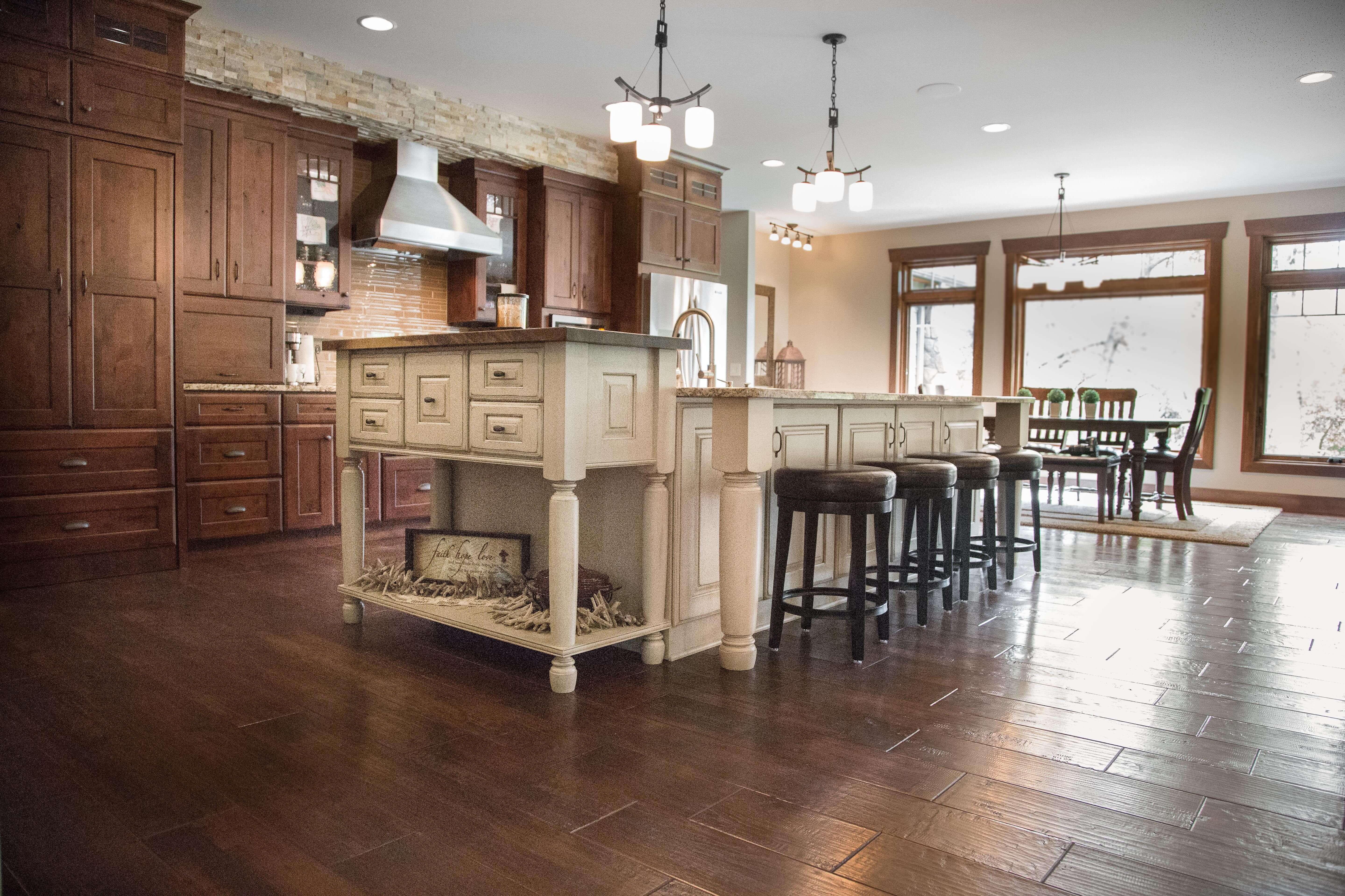 A large single wall kitchen with a kitchen island with a traditional country style featuring a rustic kitchen island.
