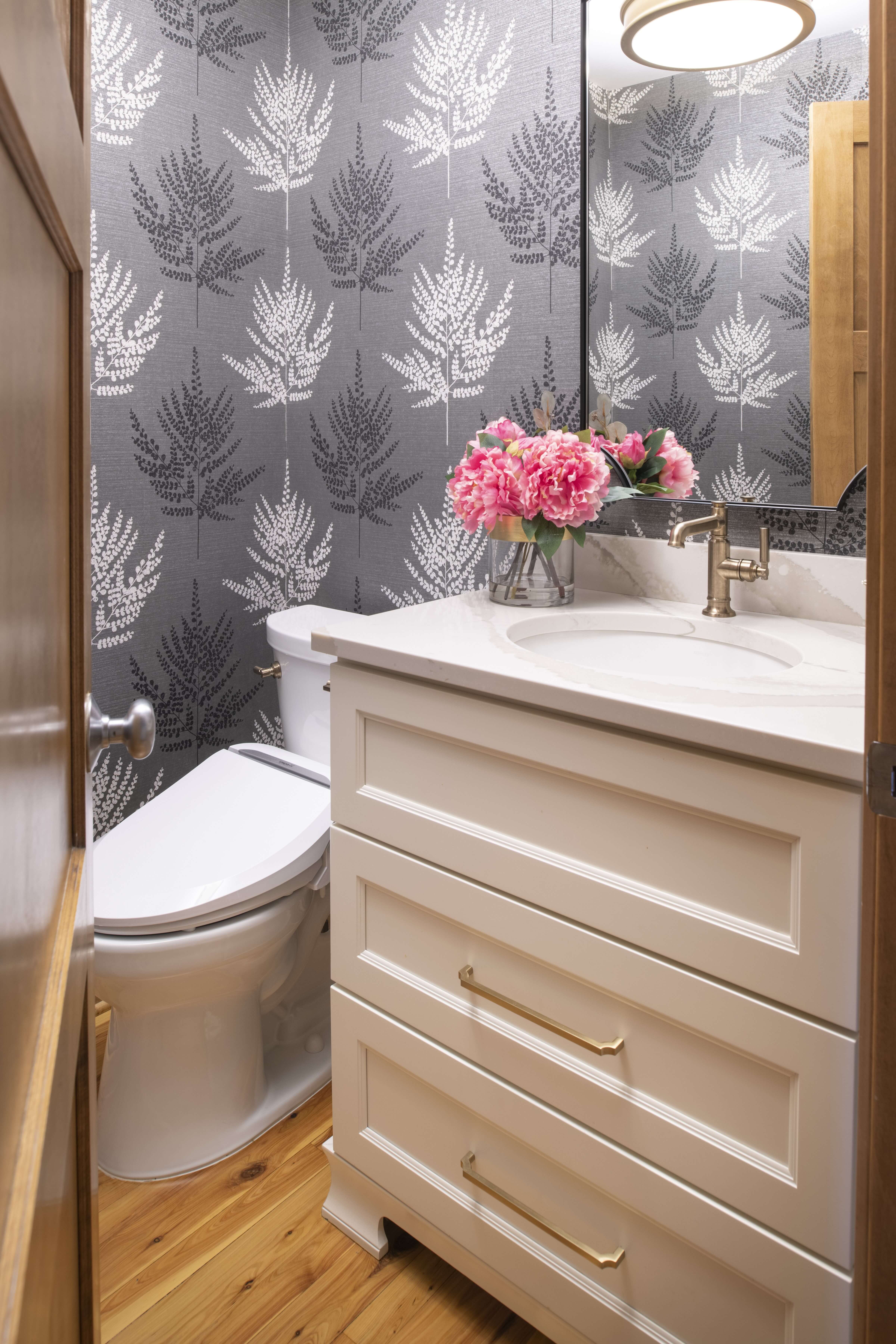 A classic white painted bath vanity with a furniture style look with a unique decorative toe and toe kick molding details.