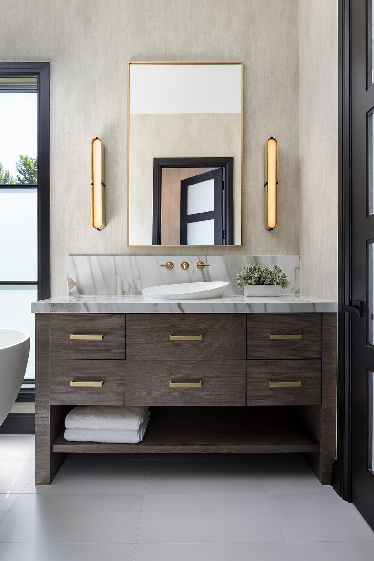 A modern straight grain oak vanity with an open floating shelf below for a custom furniture look.