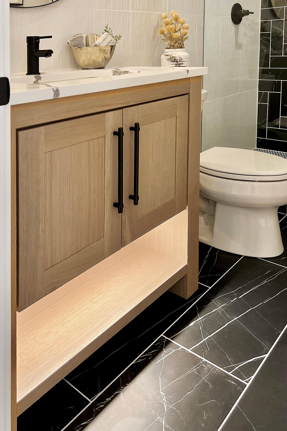 A modern farmhouse styled vanity with a simplified furniture style and floor shelf below the sink.