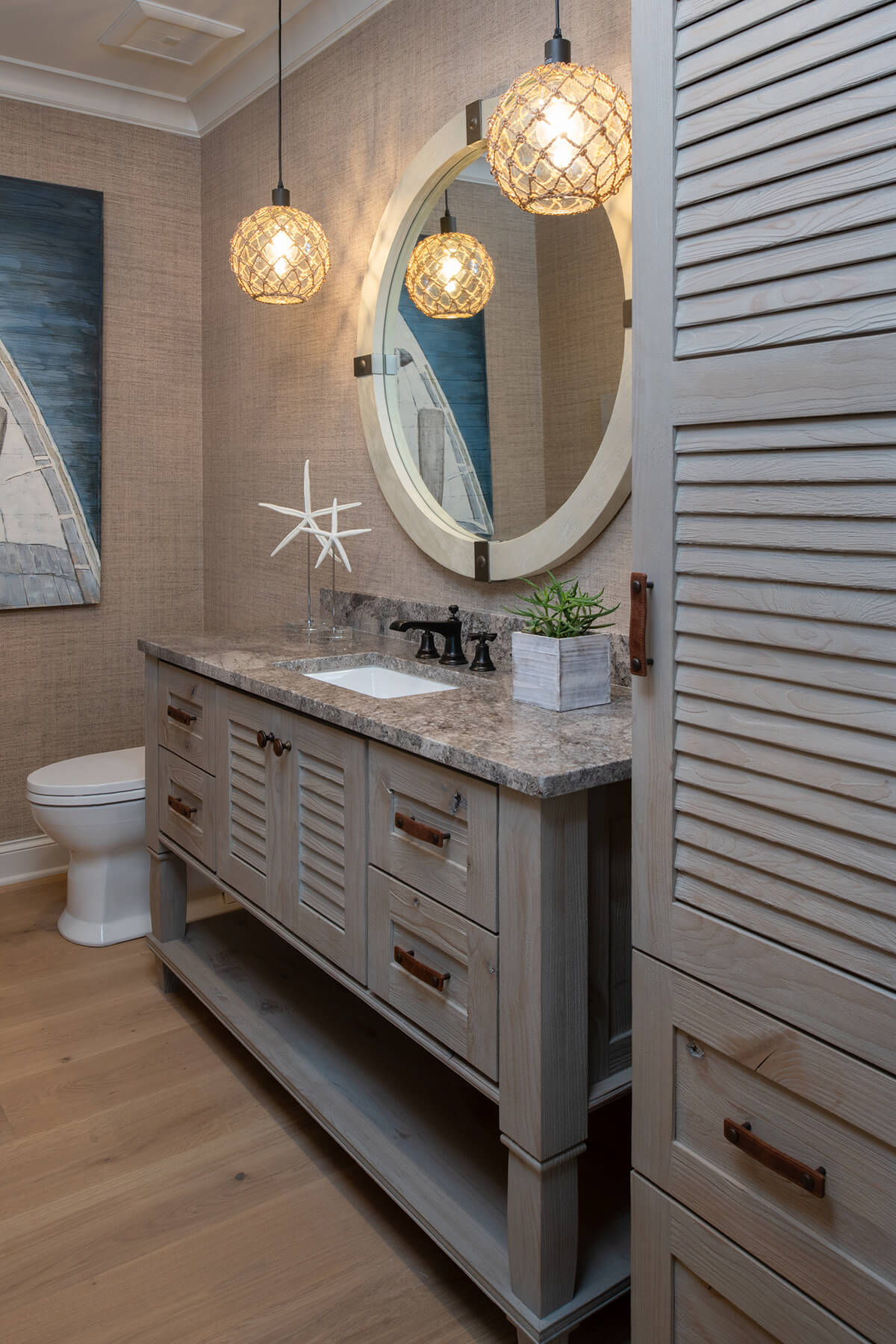 A nautical, beachy styled bathroom with a collection of matching bath furniture from Dura Supreme Cabinetry.